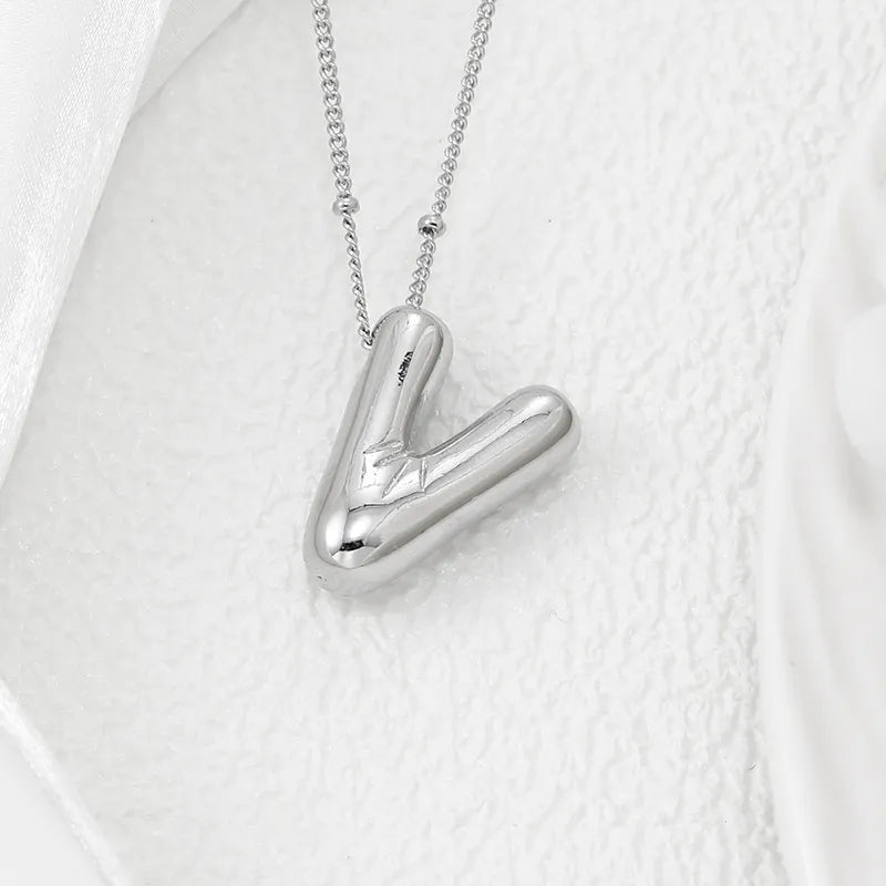 Silver letter V pendant necklace with a delicate chain.