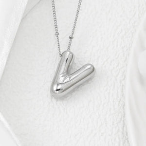 Silver letter V pendant necklace with a delicate chain.