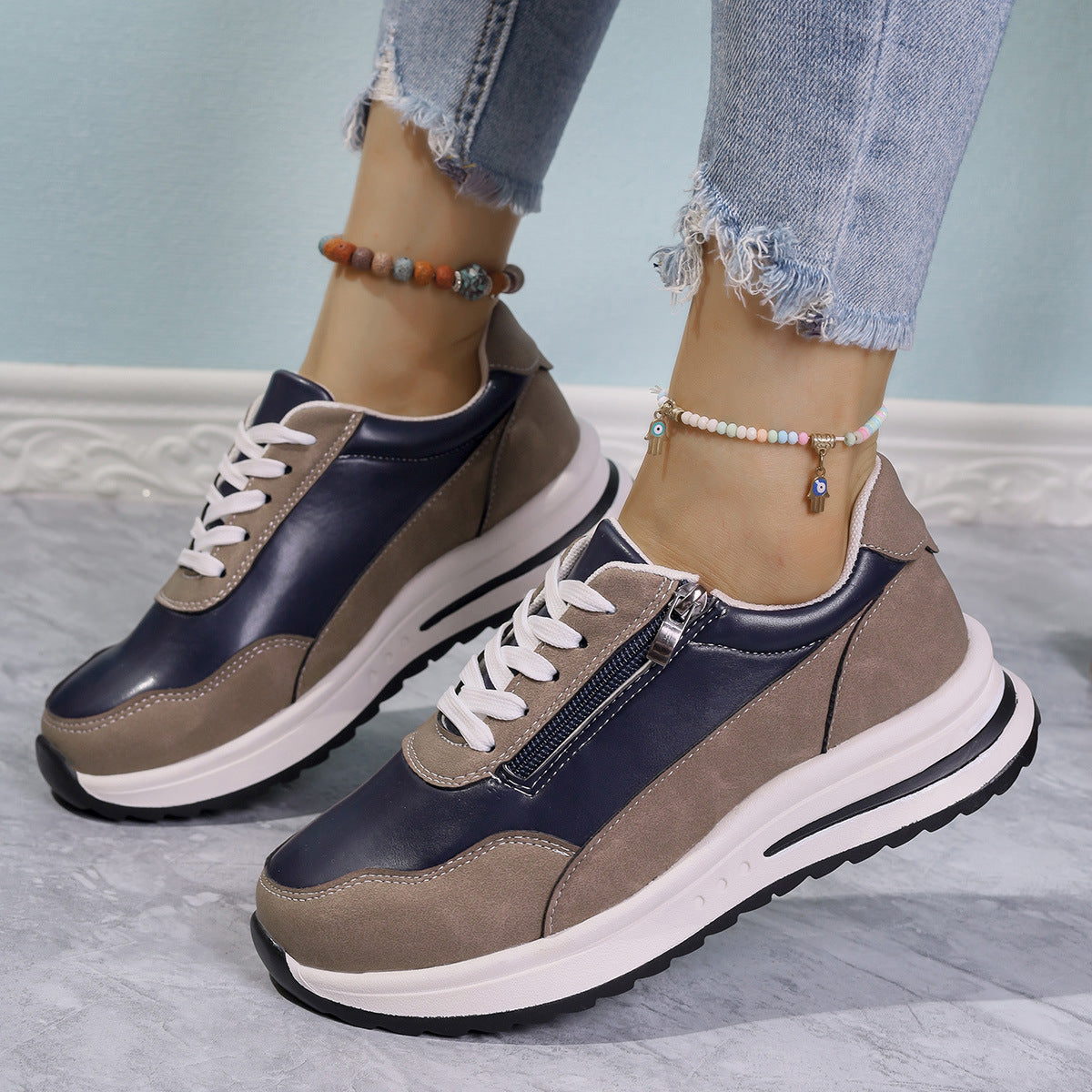 Zipper detail lace up sneakers in navy and taupe with a chunky sole.