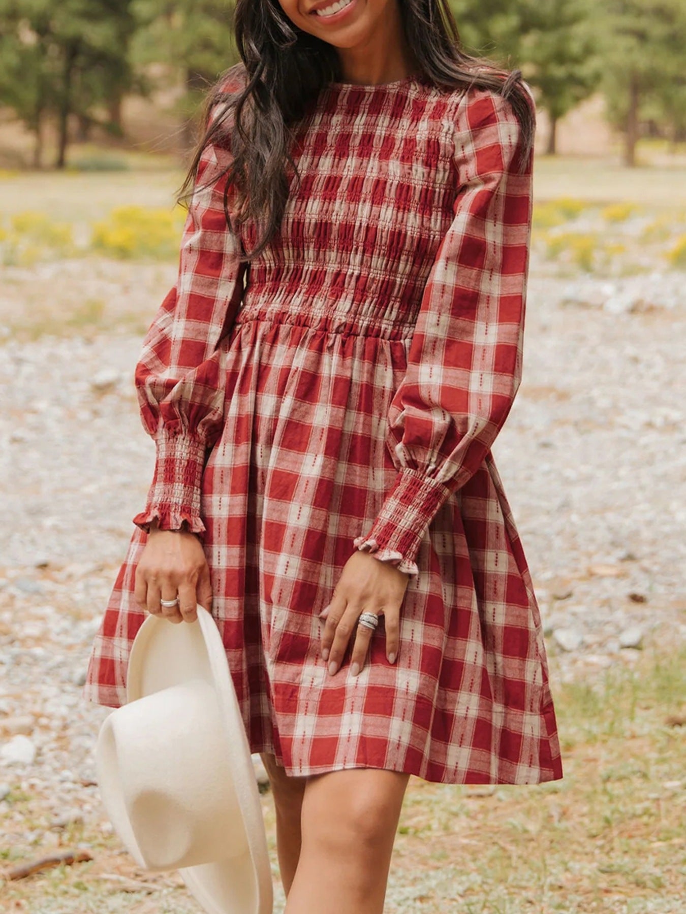 Red plaid cotton mini dress with smocked bodice and puff sleeves.