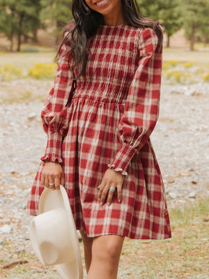 Red plaid cotton mini dress with smocked bodice and puff sleeves.