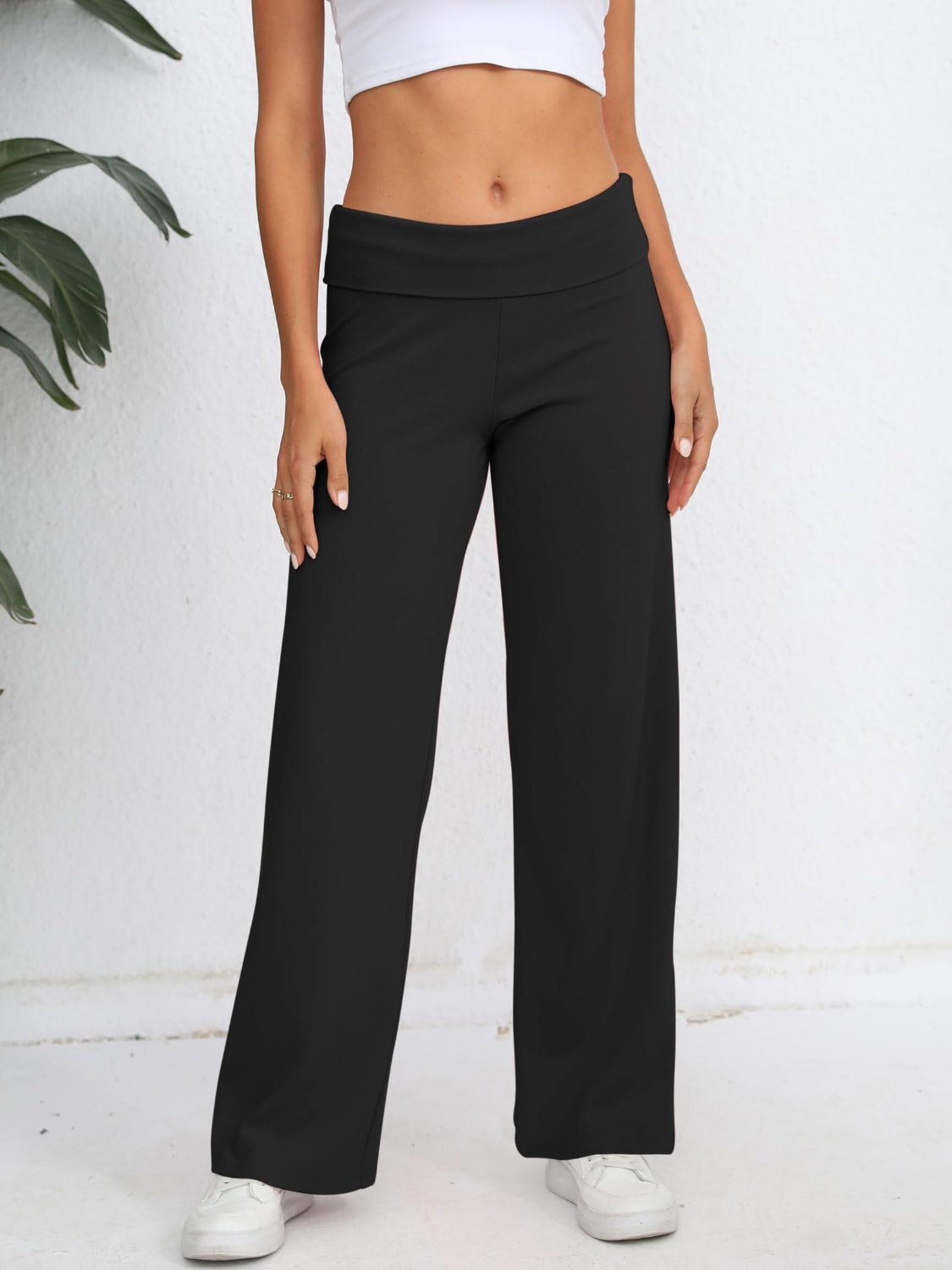 Black palazzo trousers with fold-over waistband, wide leg, and full length.