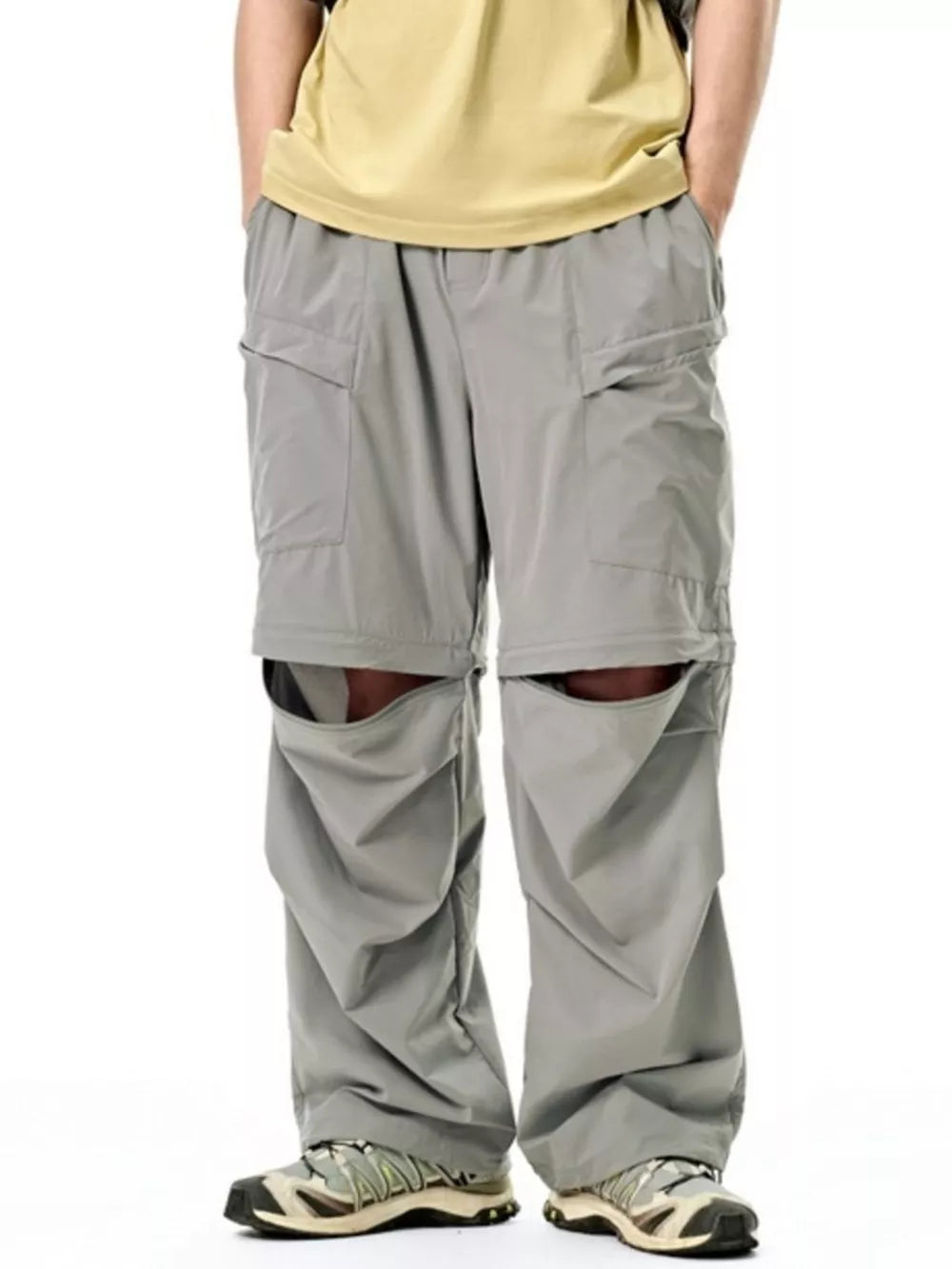 Gray cargo pants with adjustable waist and zip-off legs, showing the shorts conversion.