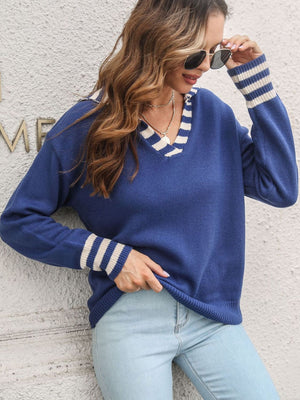Royal blue acrylic knit sweater with white striped V-neck and cuffs.