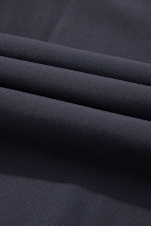 Dark gray gathered-leg jumpsuit fabric detail