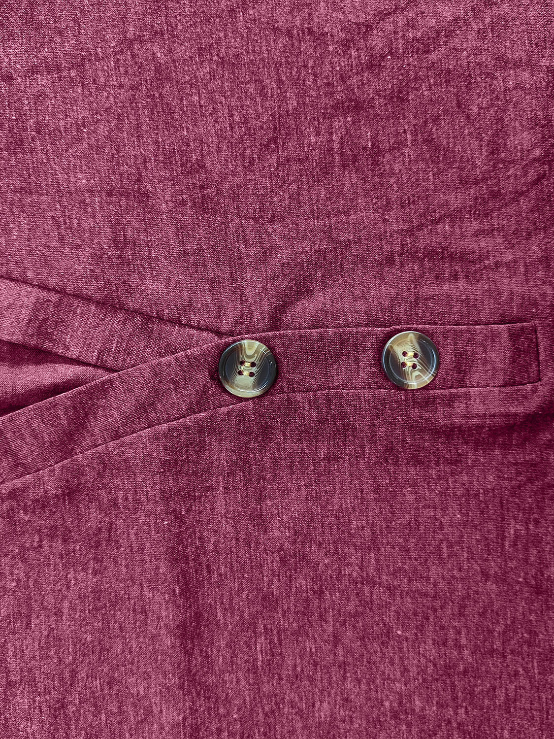 Buttoned Henley slouch tee in cerise with two decorative buttons and a crossover detail.