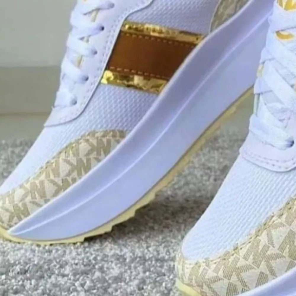 White round toe platform sneakers with beige logo print and gold stripe detail.