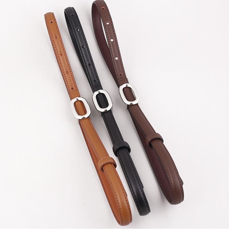Sleek cowhide leather belts in coffee brown, black, and brown with oval silver buckles.