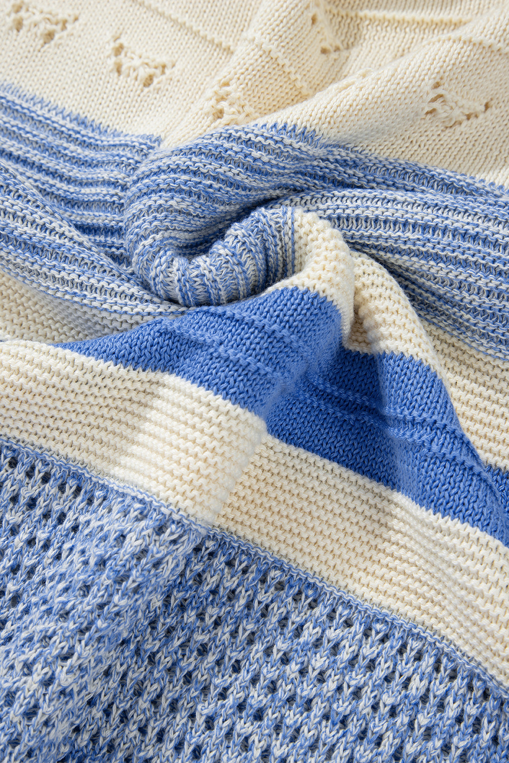 Light blue and cream striped knit sweater with eyelet yoke detail.