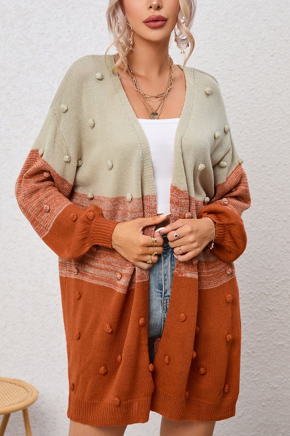 Textured colorblock acrylic cardigan in pink and caramel with bobble details and a V-neck.