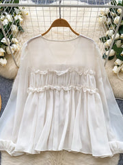 White chiffon blouse with ruffled V-neck and tie-front detail, long sleeves.