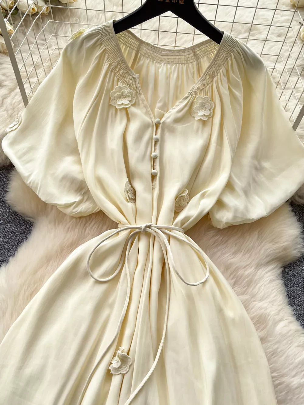 Apricot floral tie-waist maxi dress with puff sleeves and smocked neckline.