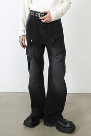 Faded black denim utility cargo pants with zip pockets and large flap pockets.