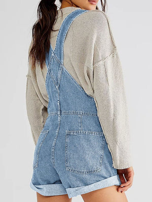 Denim short overalls in light wash with rolled hem and back pockets.