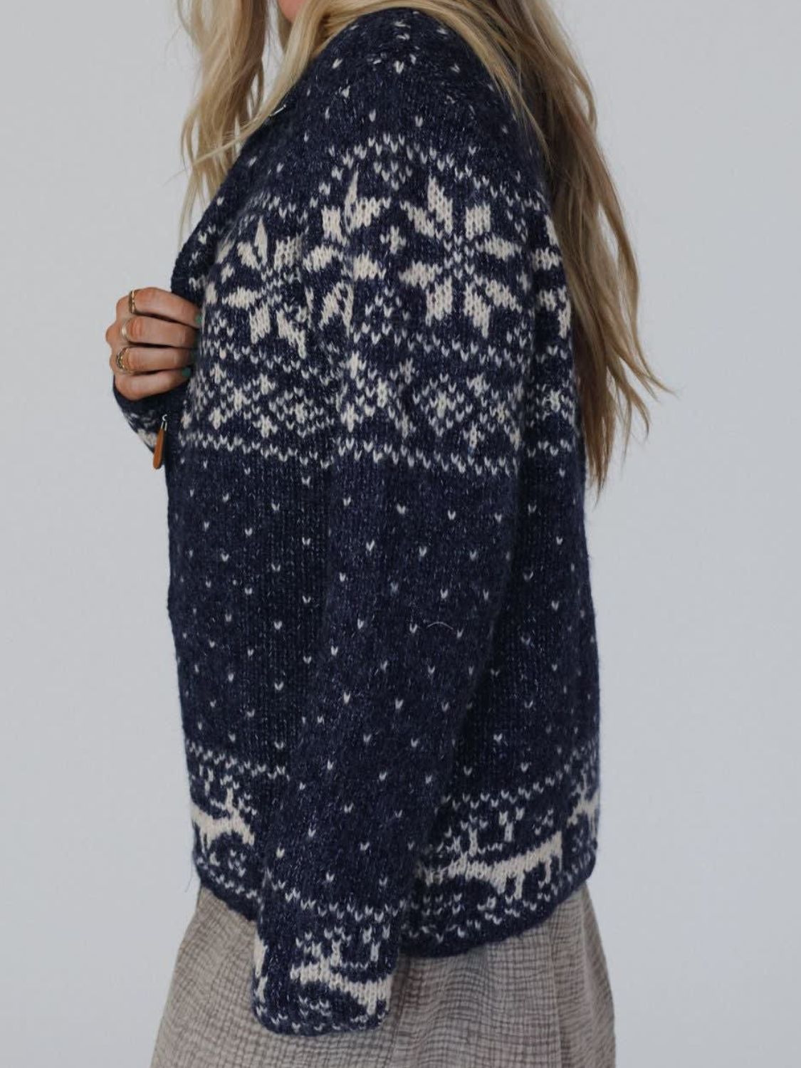 Navy acrylic Fair Isle zip-up sweater with snowflake and reindeer patterns.