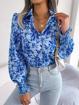 Royal blue floral print shirred cuff blouse with button front and collar.