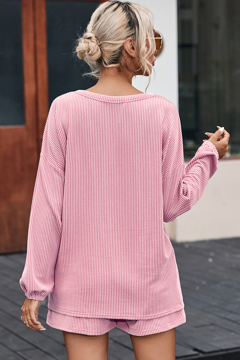 Blush pink ribbed knit outfit set with long sleeves and shorts, casual chic style.