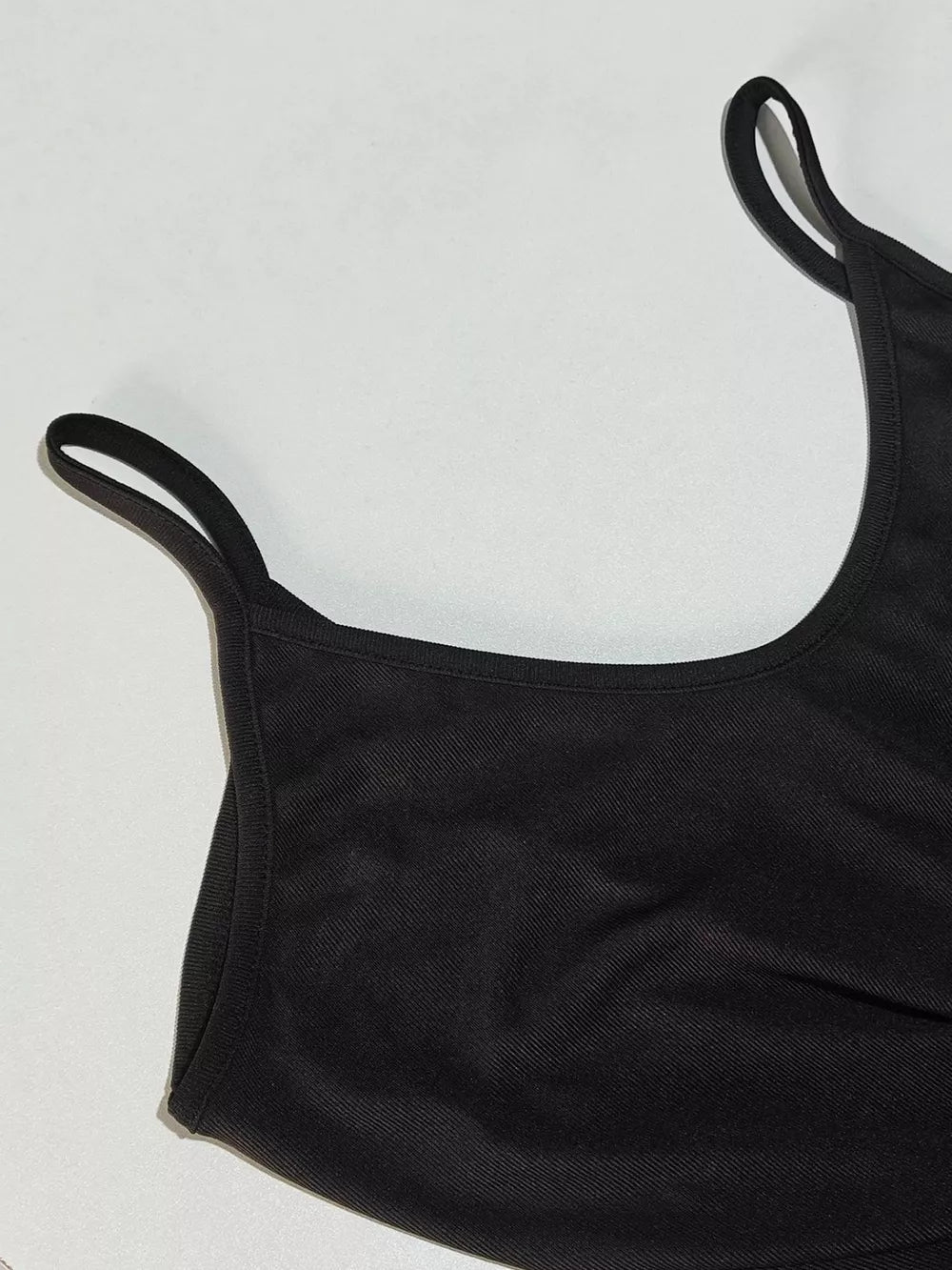 Black maxi dress with spaghetti straps and a scoop neckline.