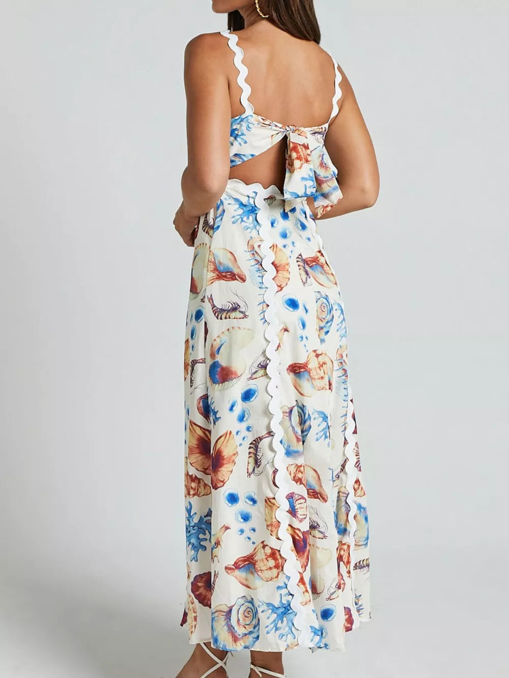 Midi dress with seashell print, scalloped trim, and back bow detail.