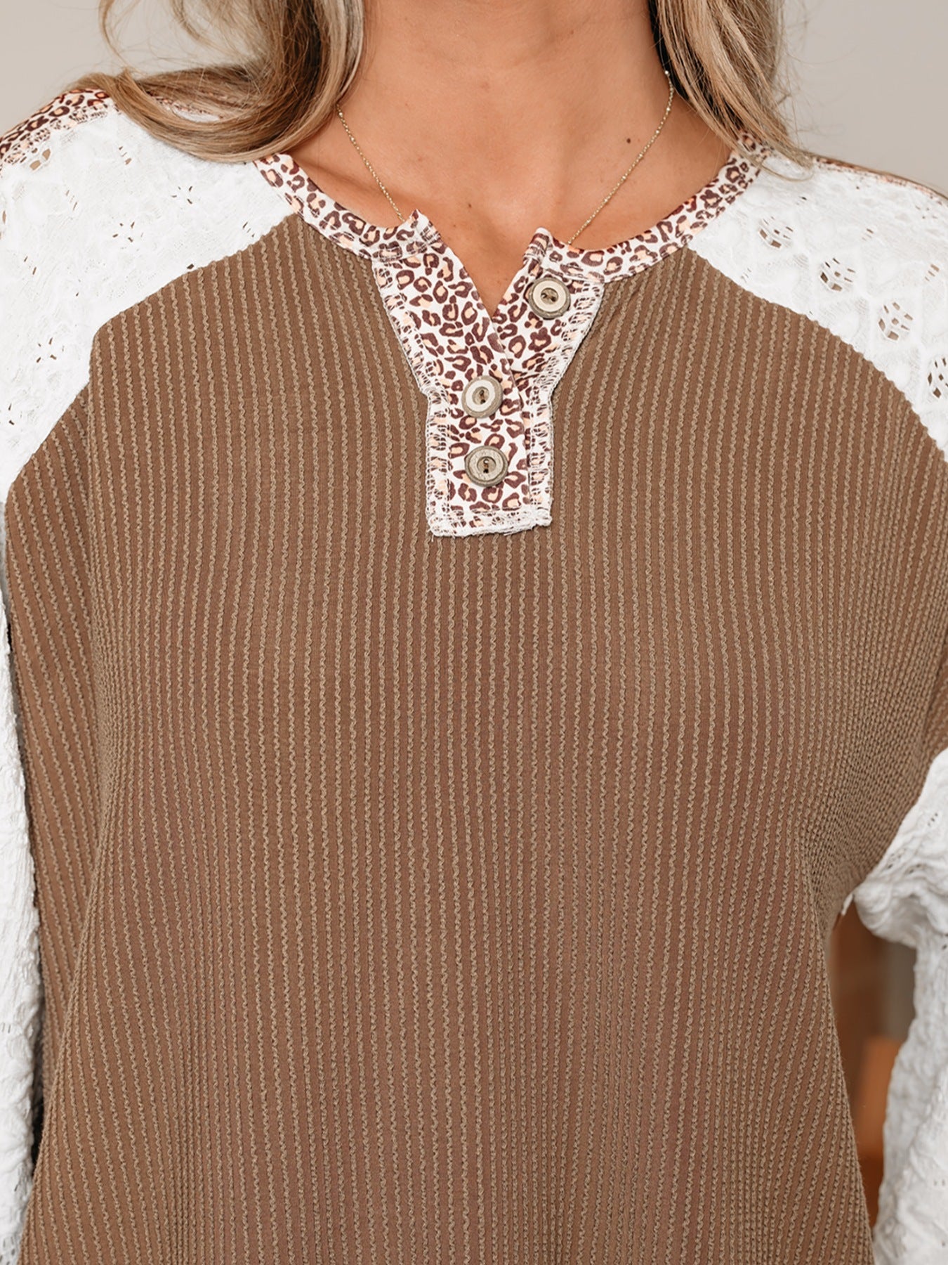 Taupe waffle knit henley with leopard print detail and lace sleeves.