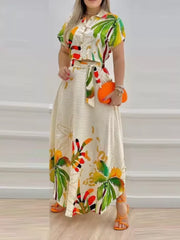 Tropical print crop top and A-line skirt set with button front and tie waist.