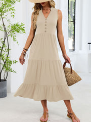 Apricot tiered midi dress with notched V-neck and decorative buttons.