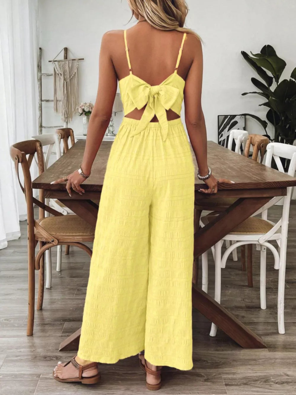 Yellow maternity romper with back bow detail and wide legs