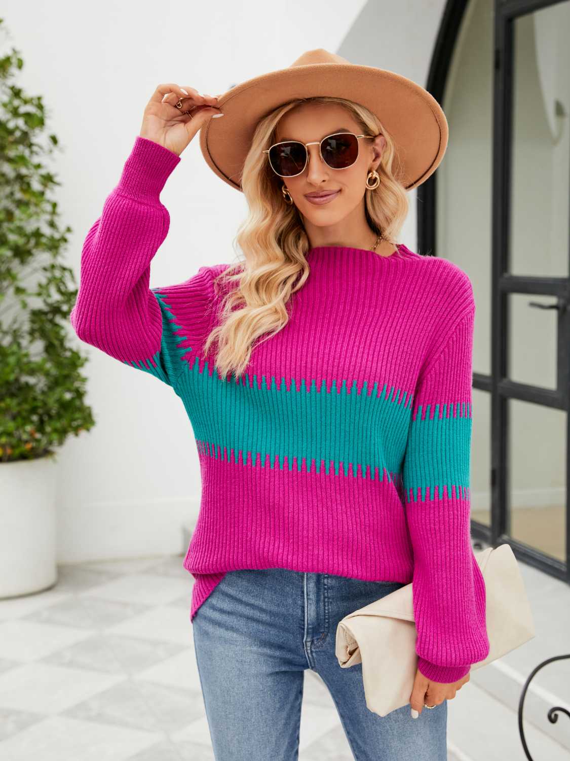 Colorblock ribbed sweater in hot pink and teal with crew neck and long sleeves.