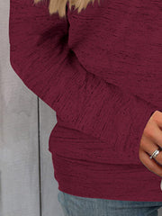 Burgundy heathered knit off-the-shoulder sweater with long sleeves.