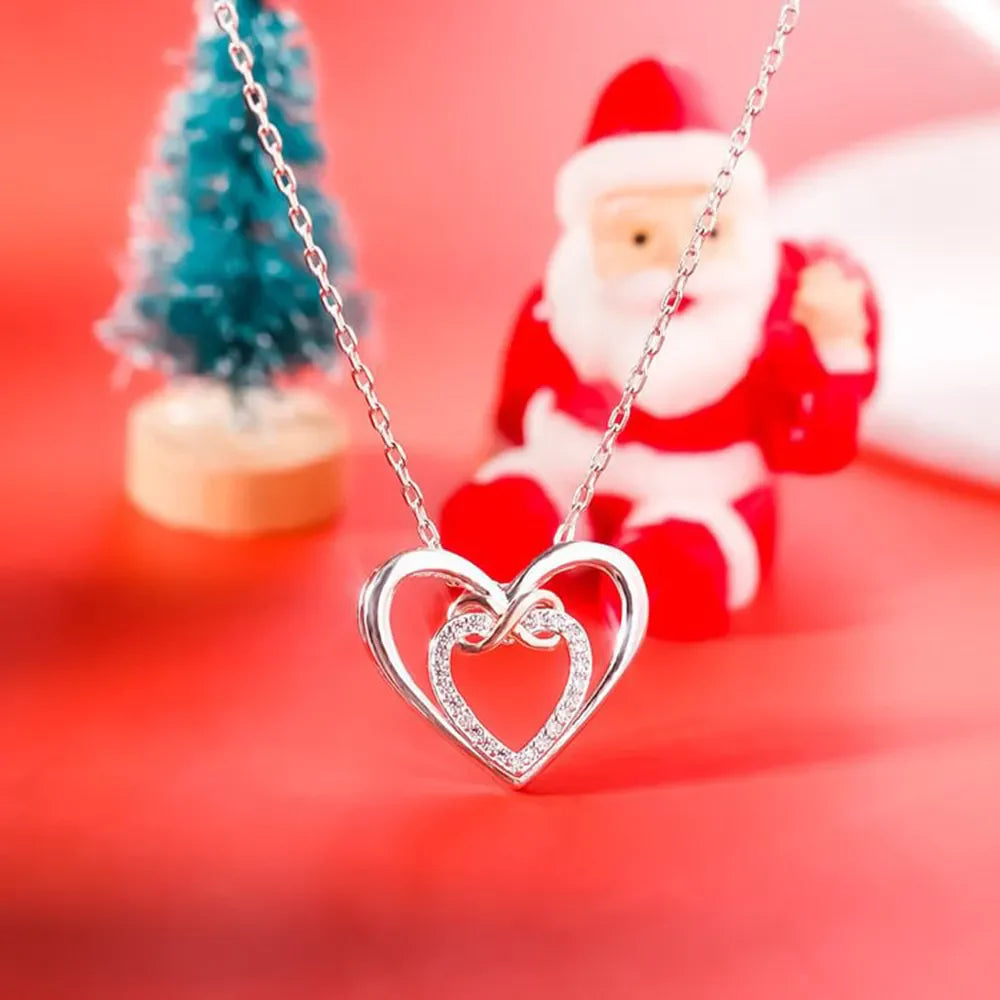 Silver double heart infinity pendant necklace with pave crystal detail.