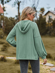 Textured knit hooded henley in Gum Leaf with balloon sleeves and button detail.