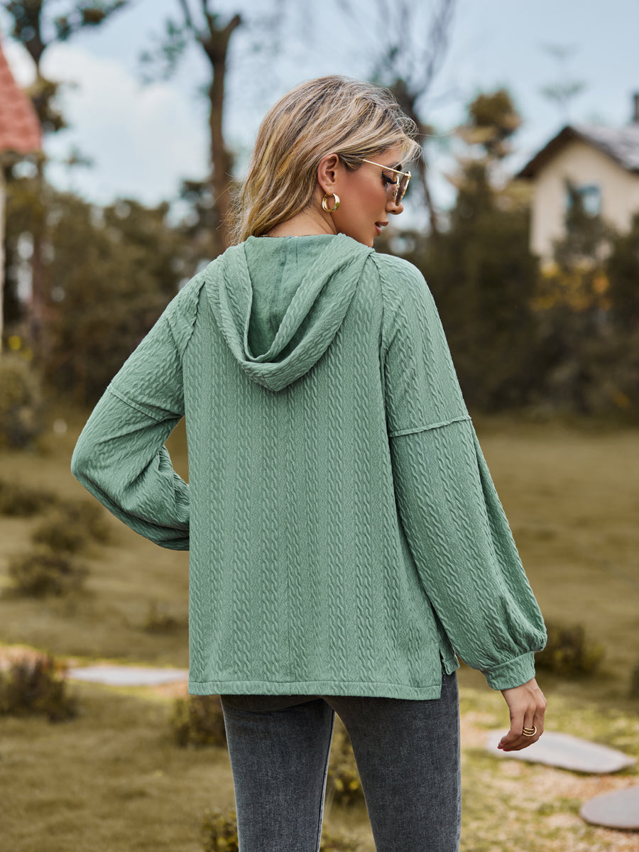 Textured knit hooded henley in Gum Leaf with balloon sleeves and button detail.