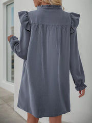 Dark gray cotton blend dress with ruffled neckline and sleeves, long sleeves, and cinched waist detail.