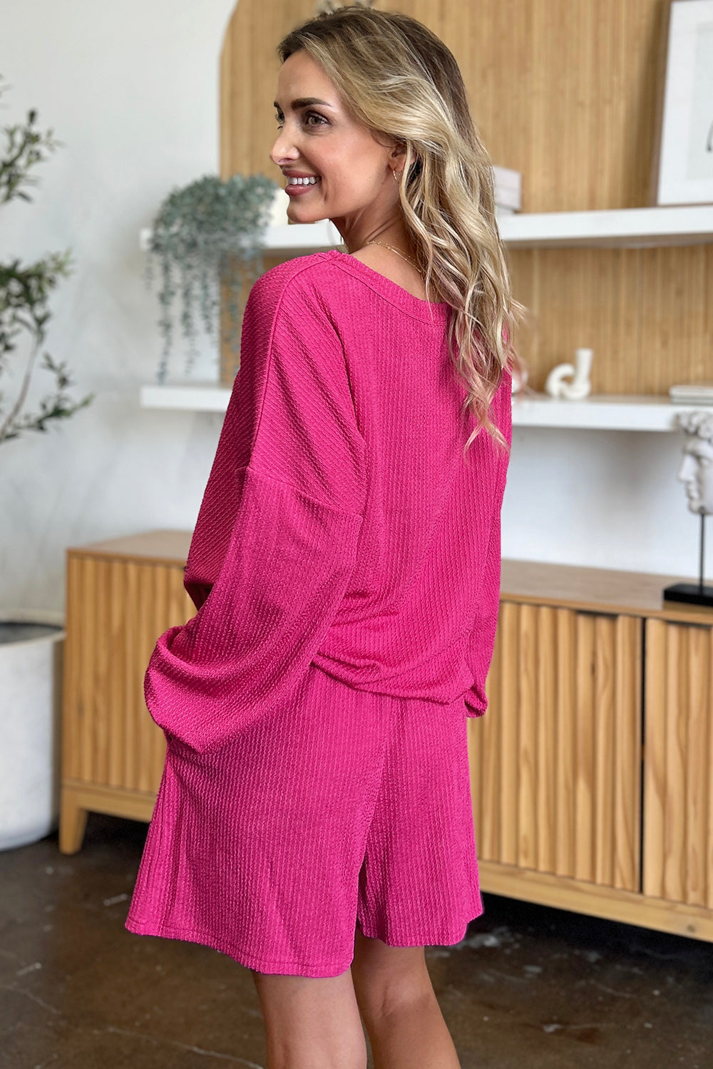 Waffle knit lounge set in hot pink with blouson sleeves and shorts.