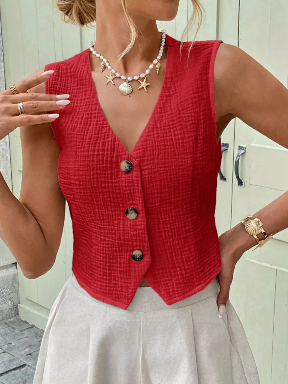 Red textured cotton button vest with V-neck and cropped length.