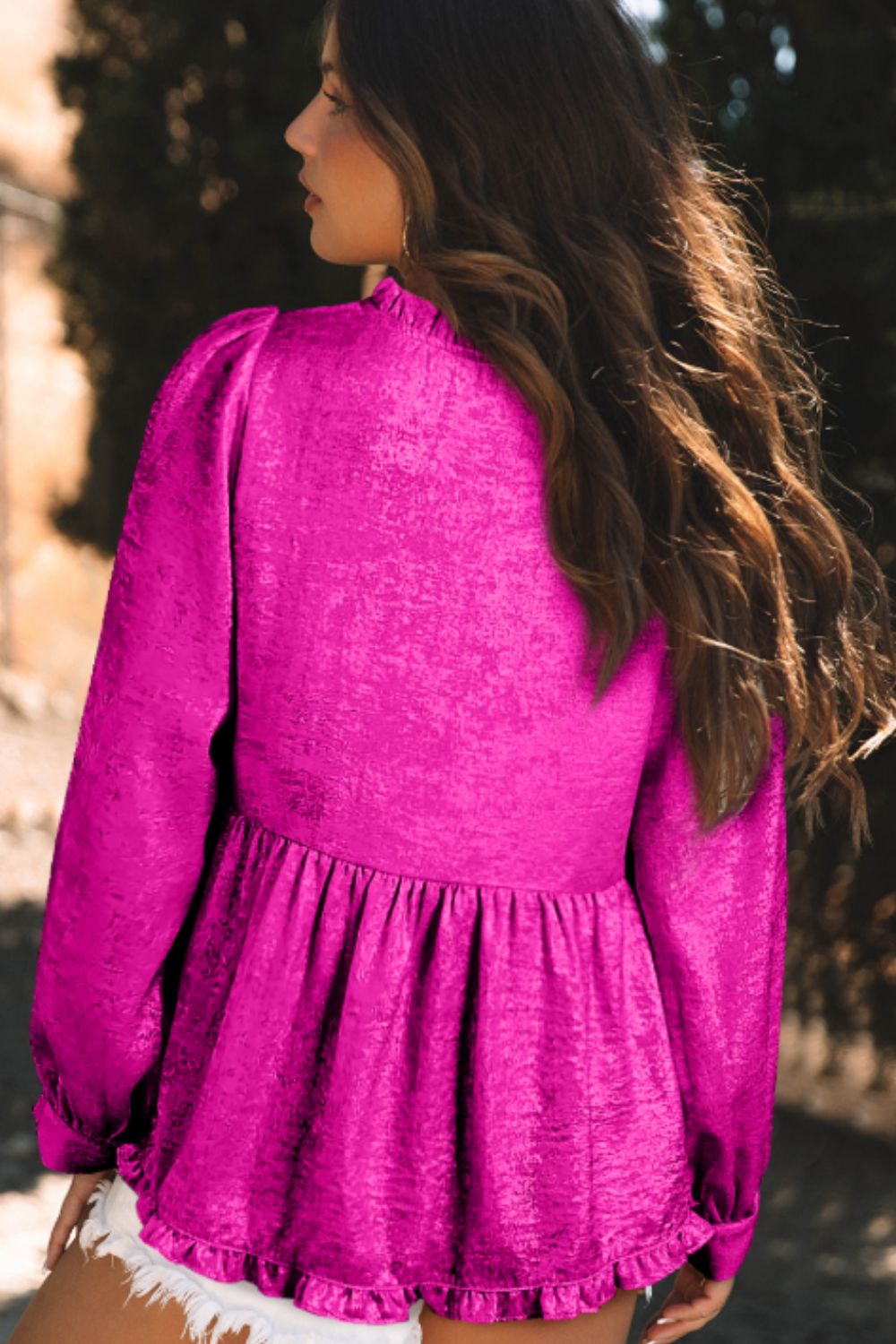Hot pink textured satin peplum blouse with ruffled hem and mock neck.