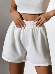 White ribbed knit crop top and high-waist shorts set with elastic waistband.