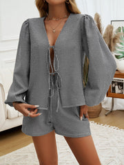 Black gingham tie-front blouse and shorts set with puff sleeves.