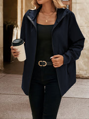 Navy zip-through hooded jacket with a relaxed fit, worn open over a black tank top.