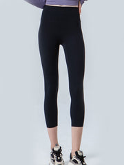 Black cropped leggings with a high waistband and subtle mesh detail at the hem.