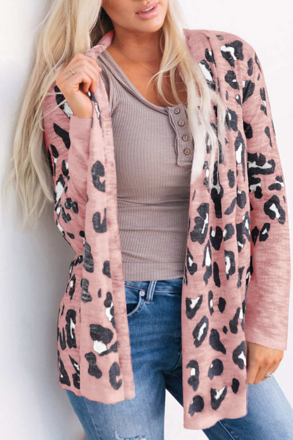 Blush leopard open-front knit cardigan with long sleeves, styled with a henley top and jeans.