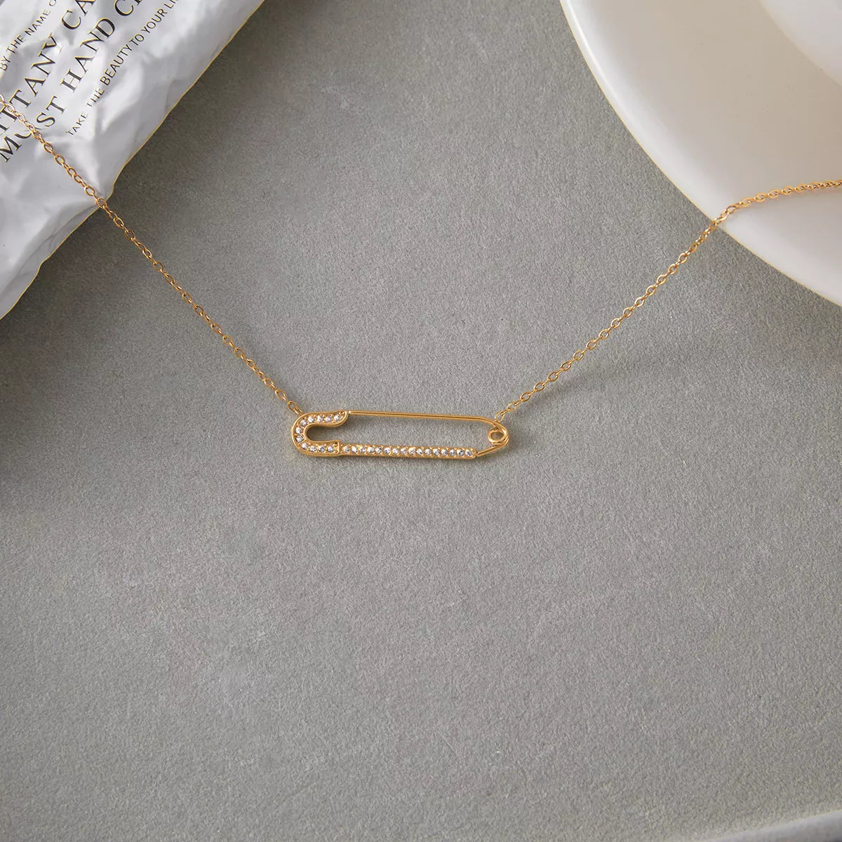 Gold paperclip necklace with pave crystal detail on a delicate chain.