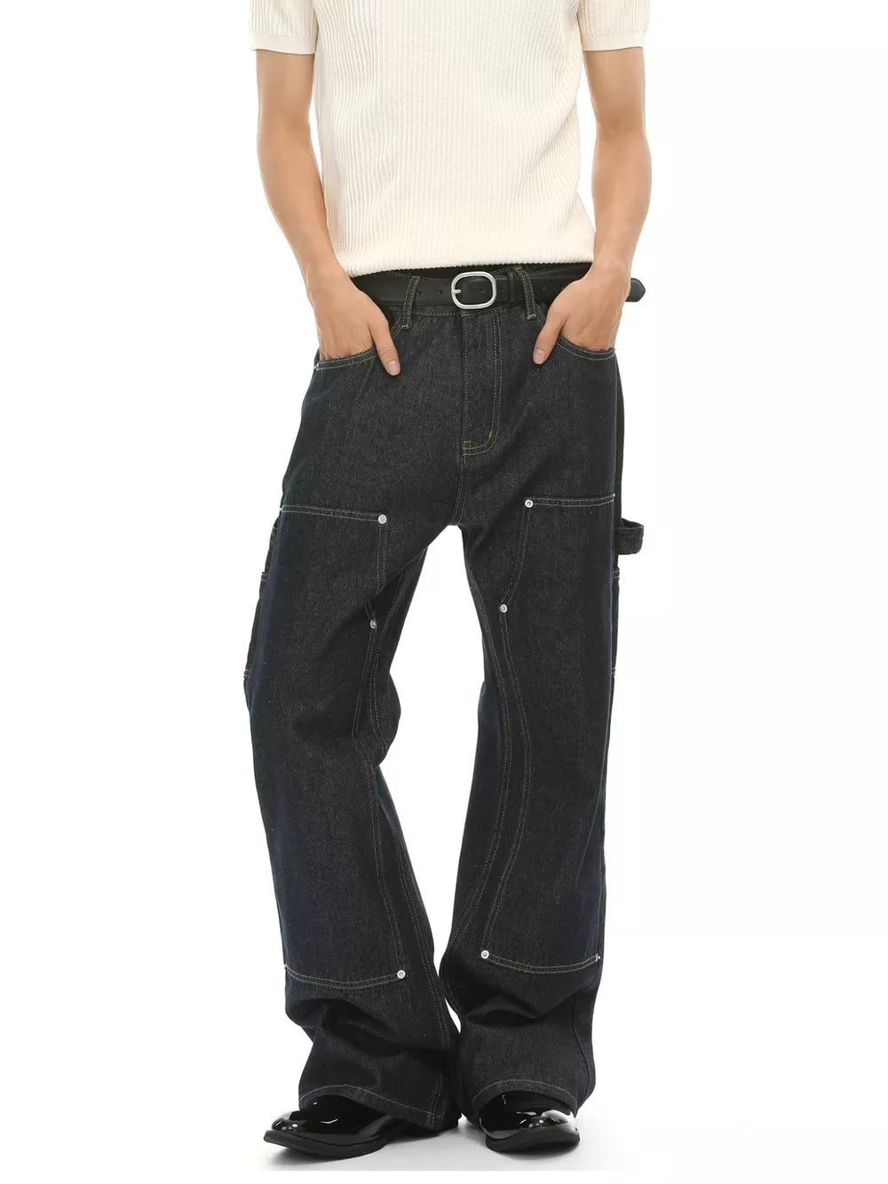 Dark wash cotton blend carpenter jeans with contrast stitching and distinctive pockets.