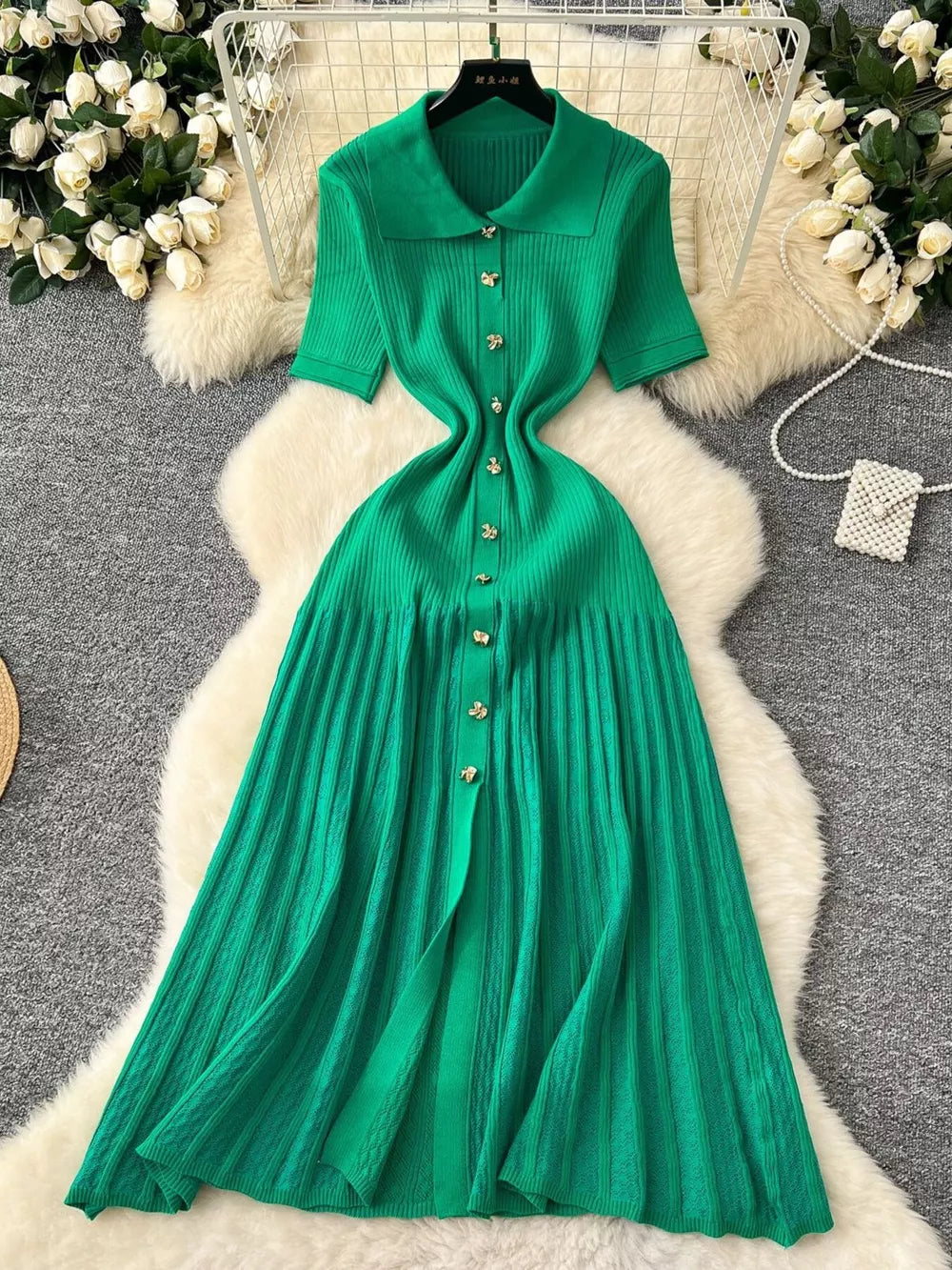 Green knit dress with Peter Pan collar, short sleeves, and button front.