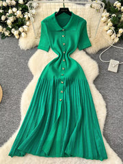 Green knit dress with Peter Pan collar, short sleeves, and button front.