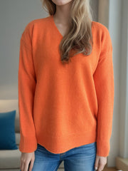 Orange V-neck acrylic knit sweater with ribbed hem and cuffs.