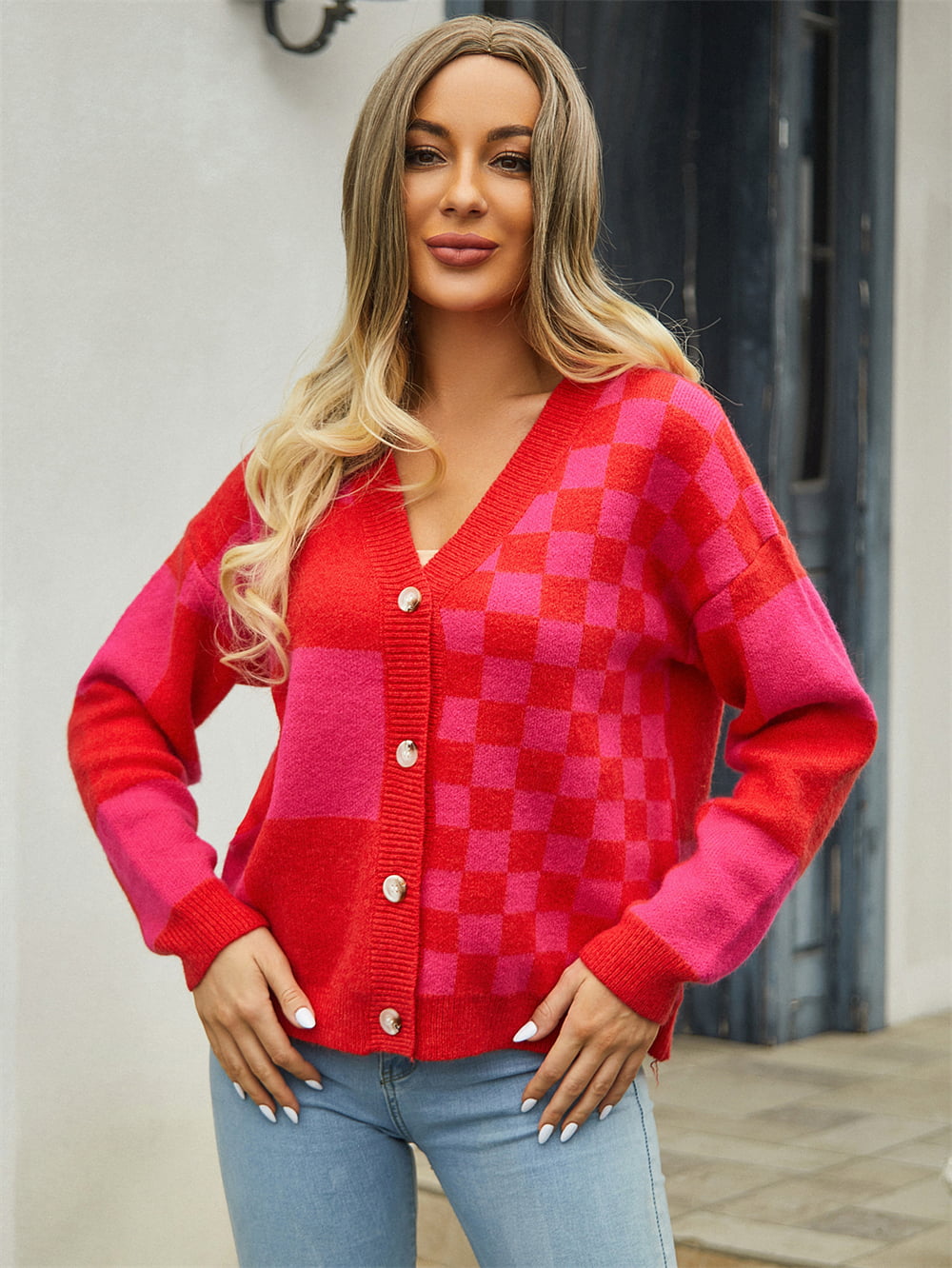 Checkerboard block knit cardigan in red and pink with button front and V-neck.
