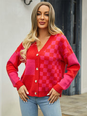 Checkerboard block knit cardigan in red and pink with button front and V-neck.