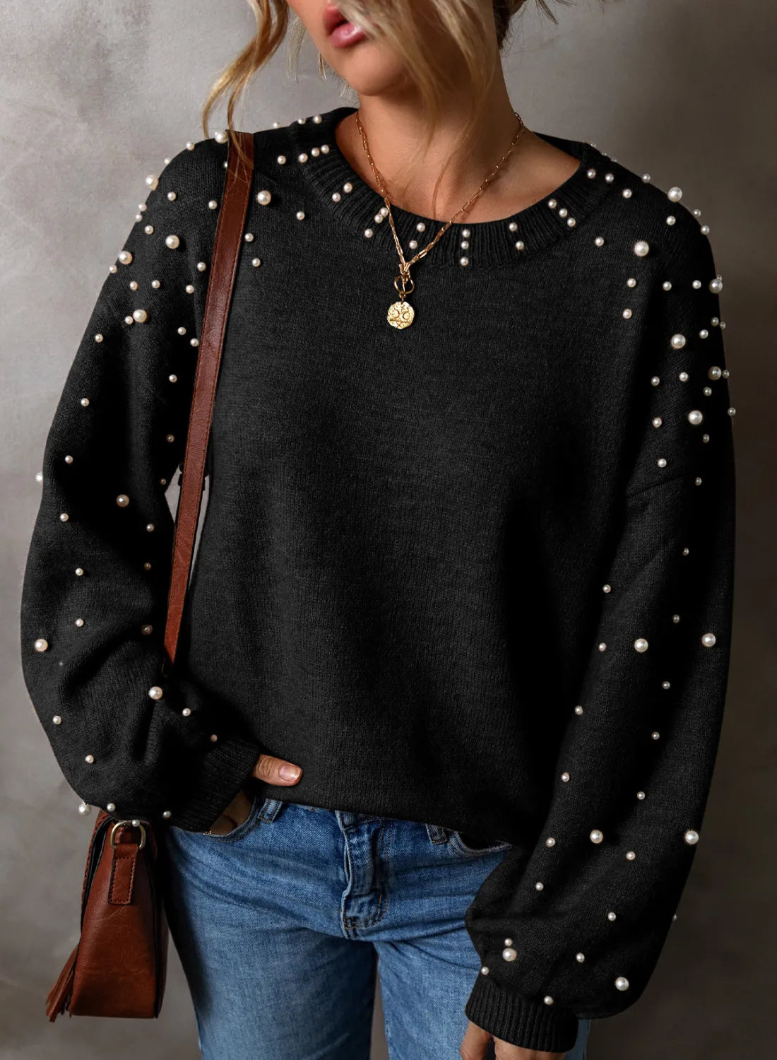 Black long sleeve sweater with pearl embellishments on sleeves and neckline, crew neck, casual knit.