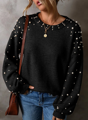 Black long sleeve sweater with pearl embellishments on sleeves and neckline, crew neck, casual knit.